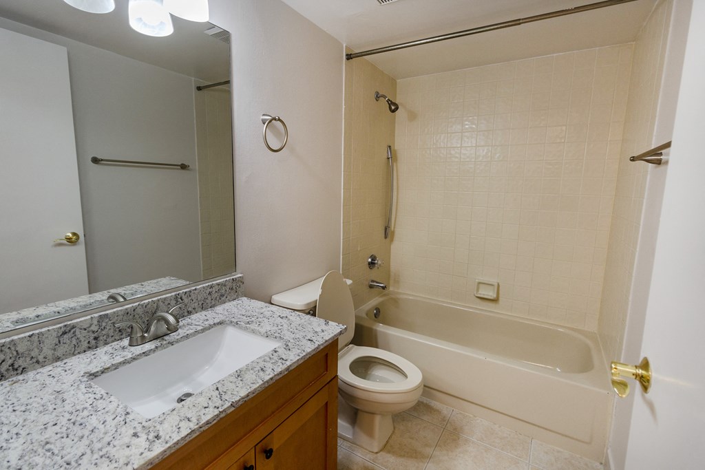 A bathroom with a sink, toilet, and bathtub.